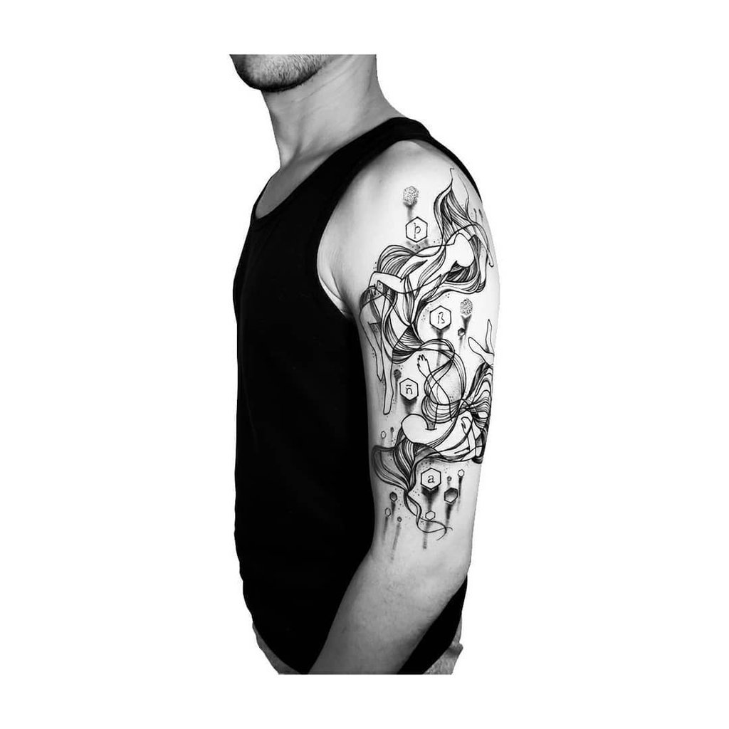 w1024-20 Homem de perfil usando regata preta com tatuagem detalhada no braço, composta por linhas fluidas e formas geométricas.