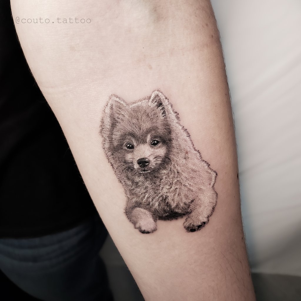 w1024-34 Tatuagem realista de um cachorro pequeno em um braço.