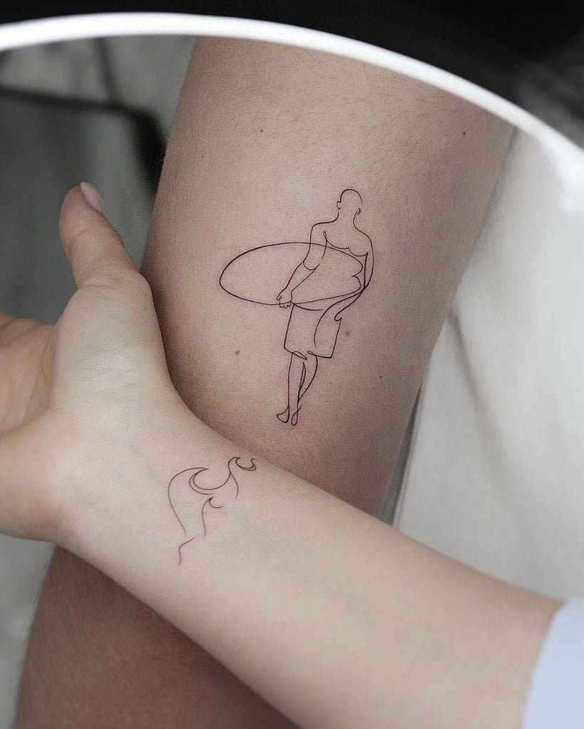 w819-196 Duas tatuagens minimalistas: uma de surfista com prancha e outra de linha ondulada em dois braços diferentes.