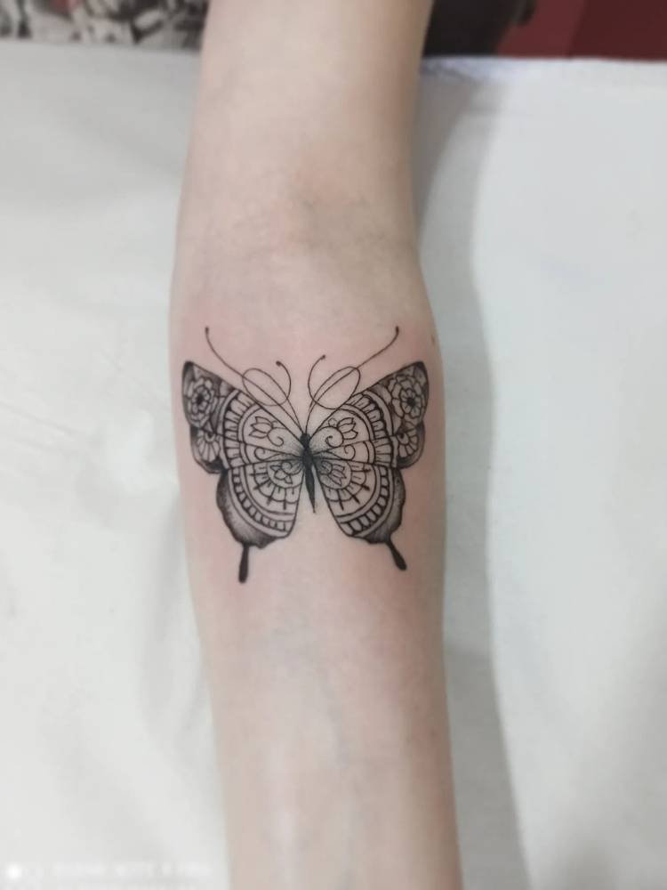 braco-detalhada-borboleta Tatuagem de traços finos cheia de detalhes nas asas. Feita no braço de uma mulher de pele branca.